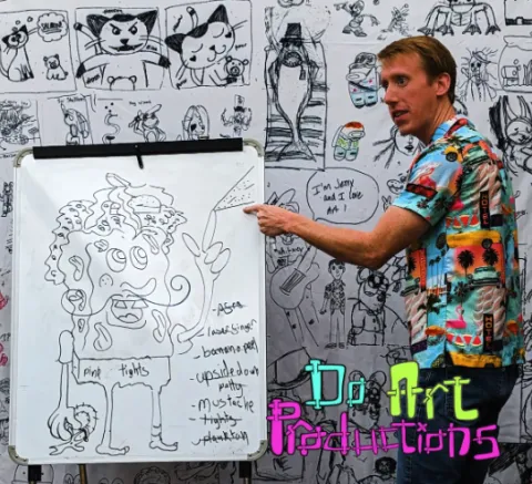 Instructor demonstrating a caricature on an easel 