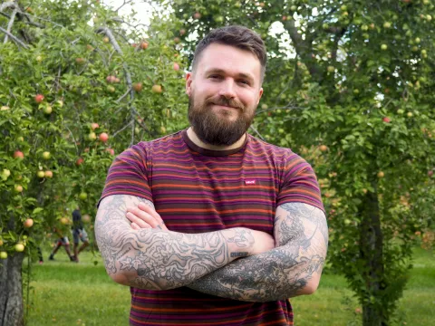 A man stands with his arms crossed